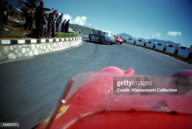 The Ferrari driven by Peter Collins and Louis Klemantaski about to overtake two slower competitors, during the Mille Miglia, May 1957. The Mercedes...