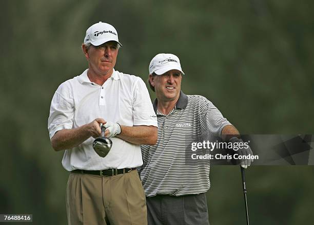 Hale Irwin prepares to tee off on while Gil Morgan watches his own ball during the second round of the Champions Tour Turtle Bay Championship at...