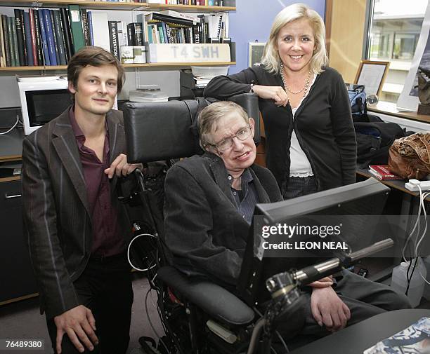 Professor Stephen Hawking, his daughter Lucy and Christophe Galfard pose for photographs in Professor Hawking's office at The Centre for Mathematical...