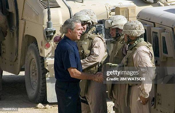 President George W. Bush greets troops as he has a meeting with Regimental Combat Team 2/MArine Wing Support Squadron Combat Patrol at Al-Asad Air...