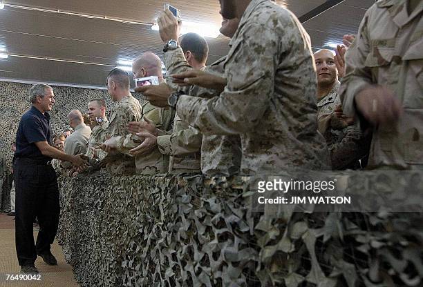 President George W. Bush shakes hands as he arrives to speak at Al-Asad Air Base in Anbar Province, Iraq, 03 September 2007. Addressing cheering...
