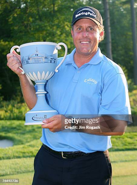 Phil Mickelson poses with the trophy after a two-stroke victory at the Deutsche Bank Championship, the second event of the new PGA TOUR Playoffs for...