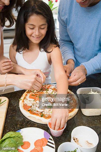 girl making pizza with her parents - arm made of vegetables stock pictures, royalty-free photos & images