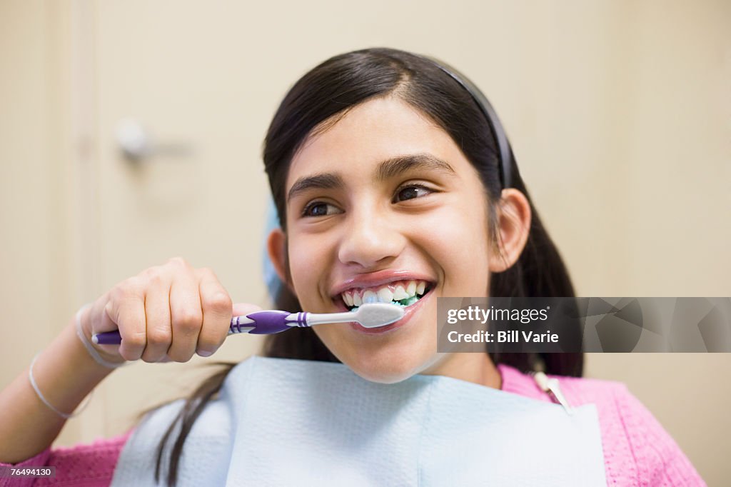 Dental patient brushing her teeth