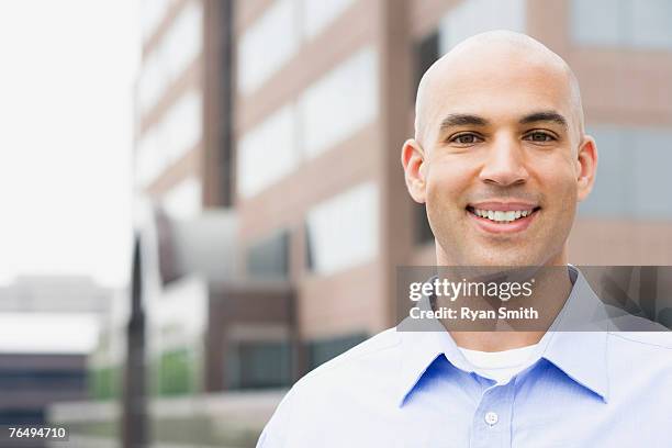 man standing outside of office building - shaved head stock pictures, royalty-free photos & images