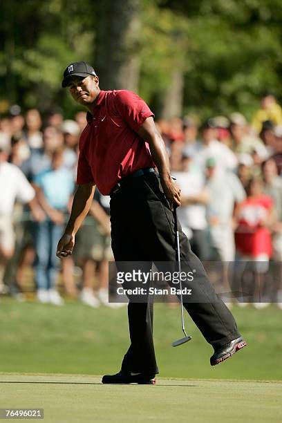 Tiger Woods watches his ball roll past the cup during the fourth round of the Deutsche Bank Championship, the second event of the new PGA TOUR...