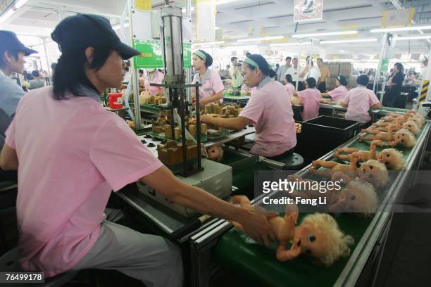 Workers assemble dolls at the production line of Jetta Industries Co., Ltd. On September 4, 2007 in Guangzhou of Guangdong Provinse, China. Two...
