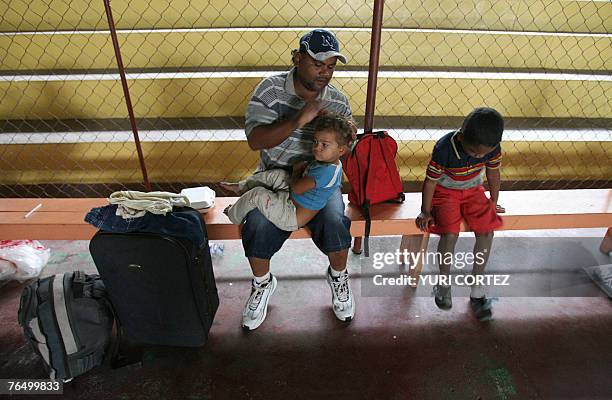 Father andh his daughters stay in a shelter 04 September 2007 at the city port of La Ceiba, Honduras, as hurricane Felix approaches. As Hurricane...