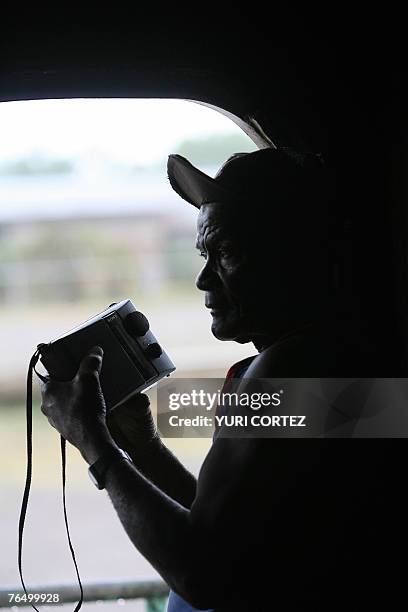 Sailor aboard "Captain Rivel I" cargo ship listens to the news on his radio at city port of La Ceiba, Honduras as hurricane Felix approaches 04...