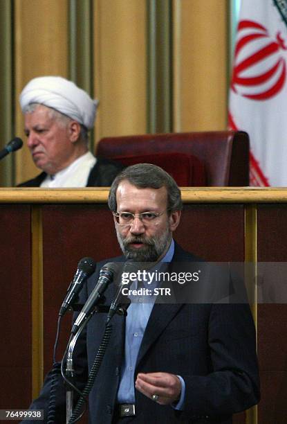 Newly elected head of Iran's Assembly of Experts Akbar Hashemi Rafsanjani listens to the head of Iran's Supreme National Security Council and top...