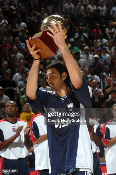 Luis Scola of Argentina receives the MVP trophy during the medal ceremony after losing to the USA Men's Senior National Team during the gold medal...