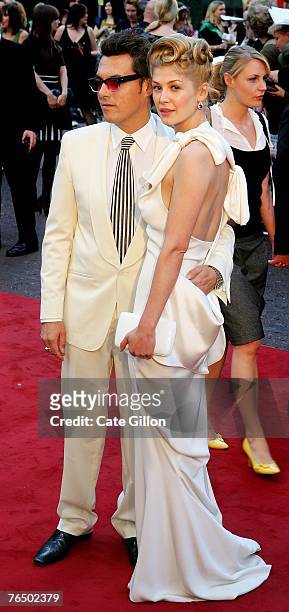 Joe Wright, the director, with actress Rosamund Pike, arriving at the UK premiere of the film 'Atonement' at the Odeon in Leicester Square on...