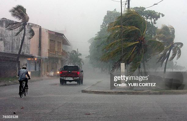 Man rides his bike during heavy rain and winds in the city port of La Ceiba, Honduras as hurricane Felix approaches 04 September 2007. As Hurricane...