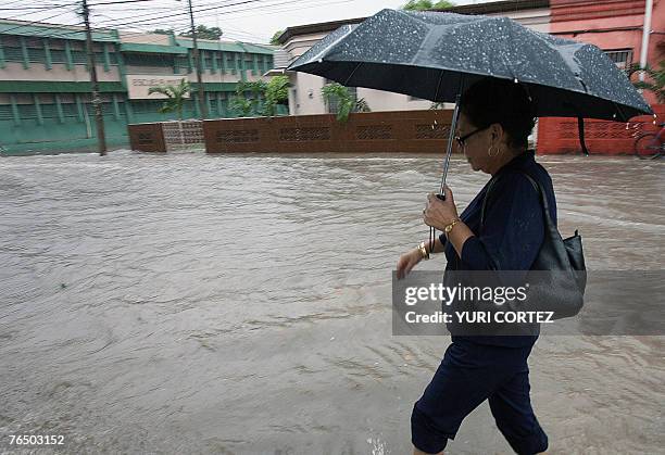 Woman walks in a flooded street of the city port of La Ceiba, Honduras as hurricane Felix approaches 04 September 2007. As Hurricane Felix slammed...