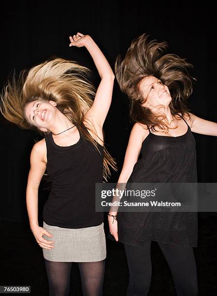 two teenage girls head banging on a dance floor sweden. - teenage girl club stock-fotos und bilder