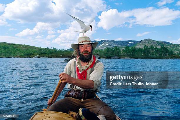 a paddler with a tern on his hat riksgransen sweden. - moustaches animales fotografías e imágenes de stock