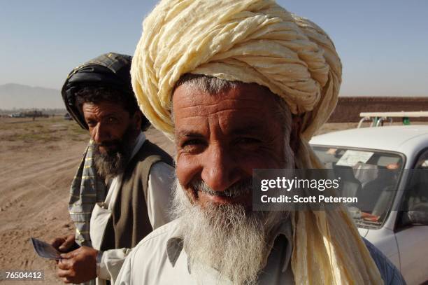 Pashtun man smiles as his car is checked, as the Afghan National Police, backed up by US Army's 82nd Airborne Division, search for unauthorized...