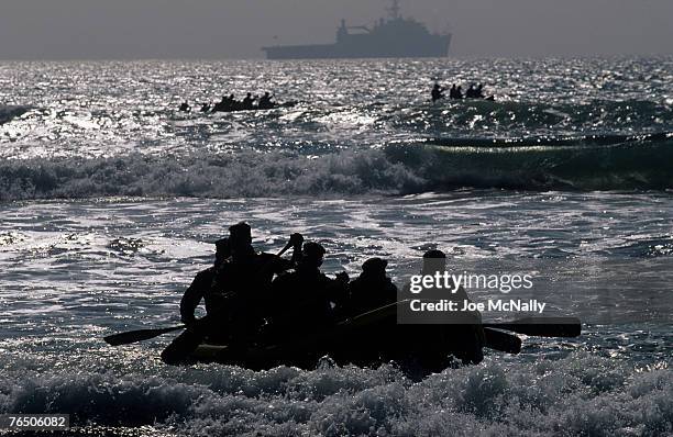 Navy Seal trainees, aboard rafts, head towards the mothership in August of 2005 during Hell Week at a beach in Coronado, California. Hell Week at...