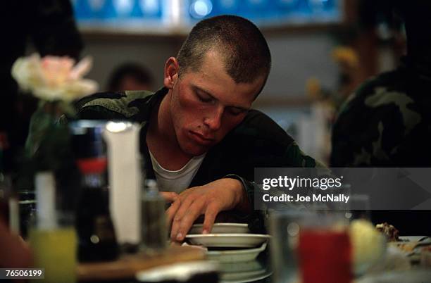 Navy Seal trainee can barely stay awake for a much needed meal in August of 2005 during Hell Week in Coronado, California. Hell Week at this beach in...