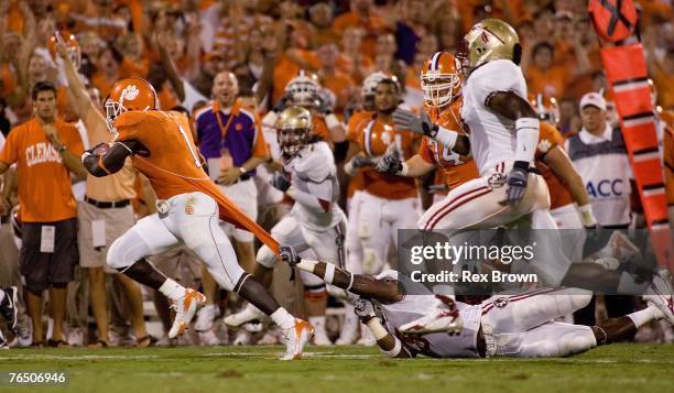 Runningback James Davis of the Clemson Tigers drags Myron Rolle of the Florida State Seminoles during the first half on September 3, 2007 in Clemson,...