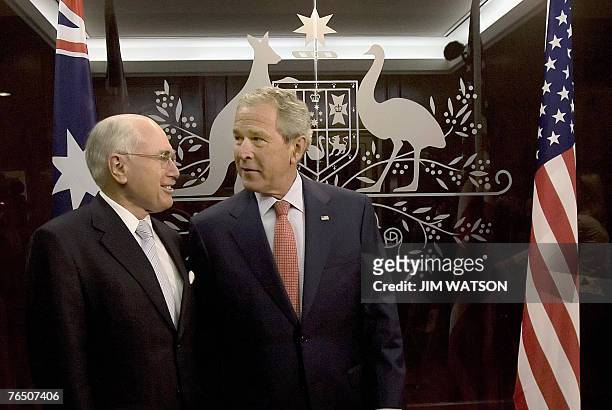 President George W. Bush and Australian Prime Minister John Howard talk before a meeting at the Commonwealth Parliament Offices in Sydney, 05...