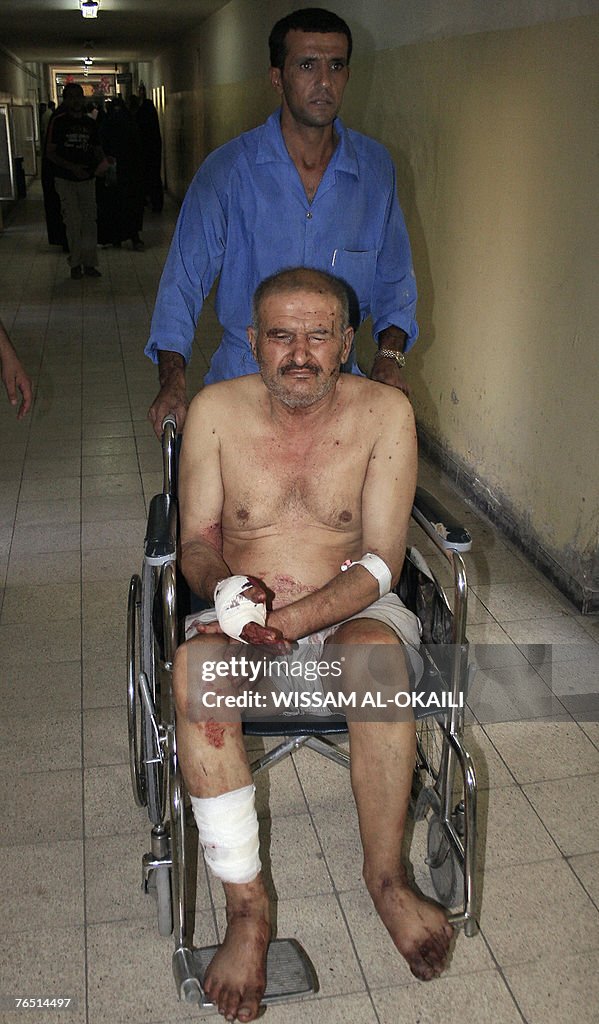 An Iraqi medic pushes a wounded man on a