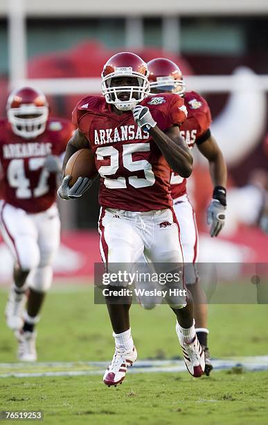 Felix Jones of the Arkansas Razorbacks returns a kickoff for a touchdown during a game against the Troy Trojans at Donald W. Reynolds Stadium on...