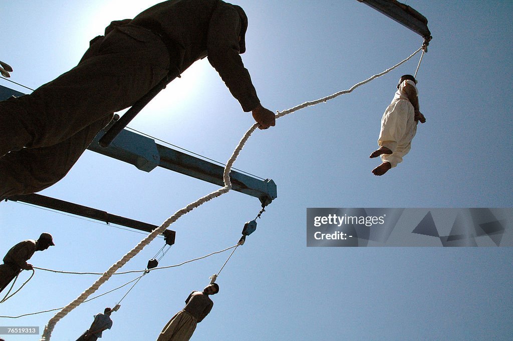 Iranian criminals hang limply from the n