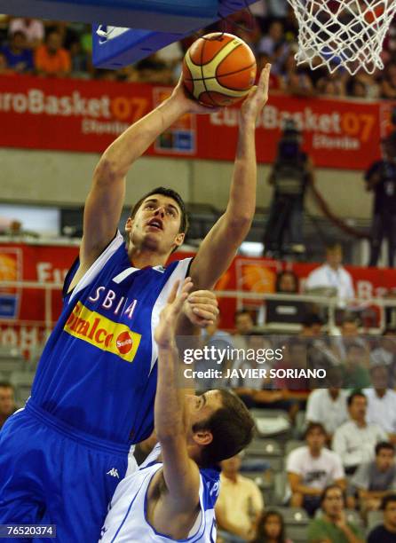 Serbia's Zoran Erceg shoots against Israel's Meir Tapiro during a preliminary round Group A match of the European Basketball Championships at the...