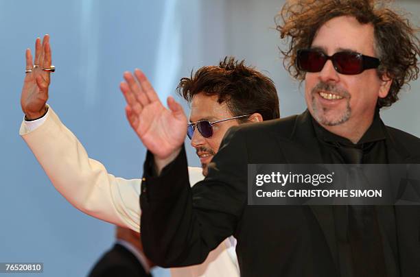 Director Tim Burton and US actor Johnny Deep wves to the fans as they arrive at the Palazzo del Cinema during the 64th Venice International Film...