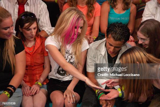 Singer Avril Lavigne shows fans her engagement and wedding rings during her appearance on MTV's "TRL" at MTV Studios in New York City's Times Square...