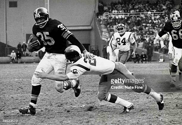 Hall of Fame halfback John Henry Johnson of the Pittsburgh Steelers runs upfield as fellow hall of famer Paul Krause attempts to tackle in a 14 to 7...