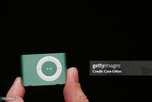 The new Ipod Shuffle, in green, is held at the UK launch of the product at the BBC on September 5, 2007 in London, England. Steve Jobs spoke to the...