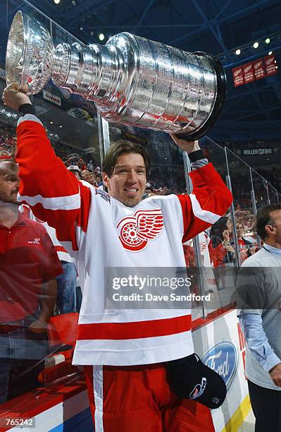 Uwe Krupp of the Detroit Red Wings raises the Stanley Cup after defeating the Carolina Hurricanes during game five of the NHL Stanley Cup Finals on...