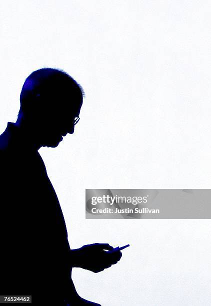 Apple CEO Steve Jobs is silhouetted by a video screen as he shows a new iPod video during an Apple Special event September 5, 2007 in San Francisco,...