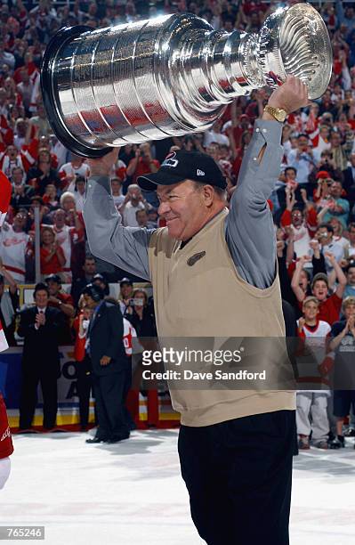 Head Coach Scotty Bowman of the Detroit Red Wings raises the Stanley Cup after defeating the Carolina Hurricanes during game five of the NHL Stanley...