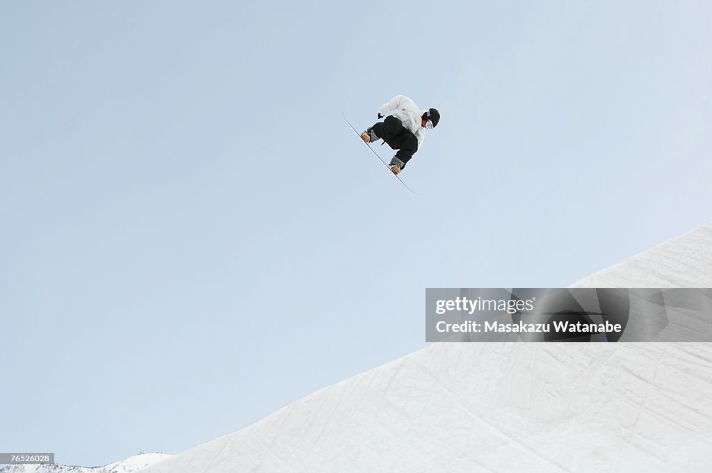 Young snowboarder airborne