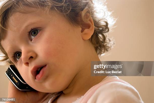 girl (0-2) using mobile phone - 0 11 months stock pictures, royalty-free photos & images