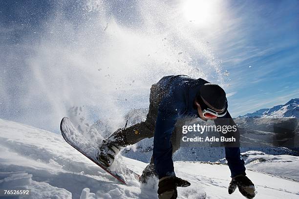 male snowboarder falling over on mountain - stumble stock pictures, royalty-free photos & images