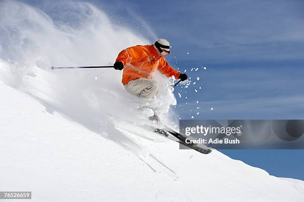 austria, saalbach, male skier jumping on slope - alpineskiën stockfoto's en -beelden