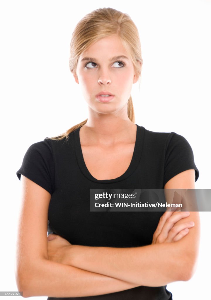 Woman with her arms crossed looking up