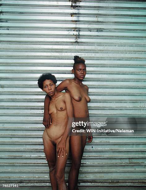 naked young women standing by shutter - pubic hair young women stock-fotos und bilder