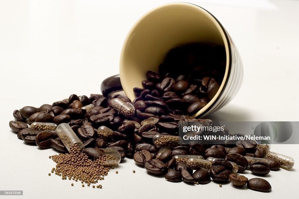 Coffee beans spilling out of cup