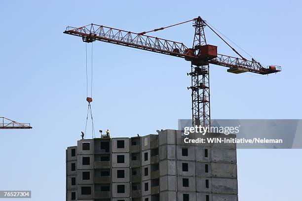 construction crane against clear sky - crane building photos et images de collection