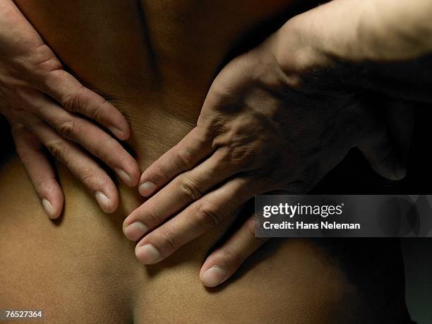 hands on the nape of woman's back - nape of neck stock pictures, royalty-free photos & images
