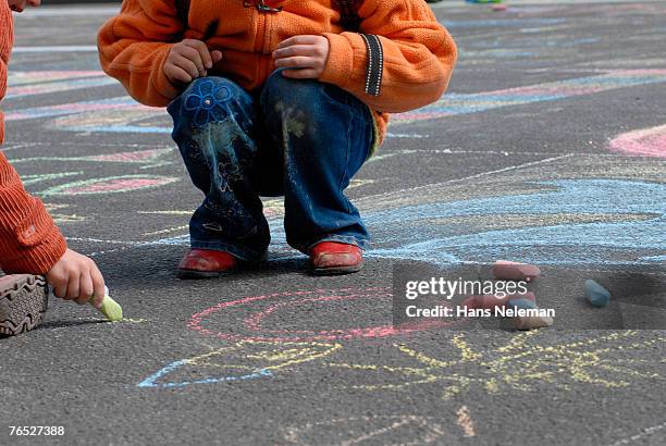 children drawing with chalk on street, low section - lower stock-fotos und bilder