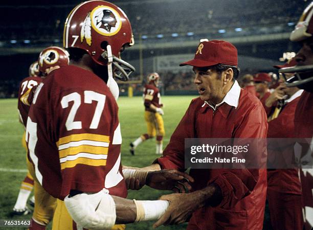 Washington Redskins head coach George Allen speaks with safety Ken Houston during a 14-7 victory over the New York Jets on September 9 at RFK Stadium...