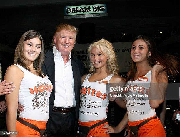 Donald J.Trump poses with Hooters Girls at the Donald Trump's Ultimate Deal Cash Giveaway at the Trump Marina Hotel and Casino on September 1, 2007...
