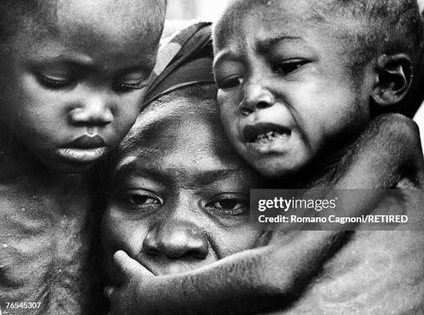 Two children cling to their mother in Biafra, a secessionist state in Nigeria, 1970.