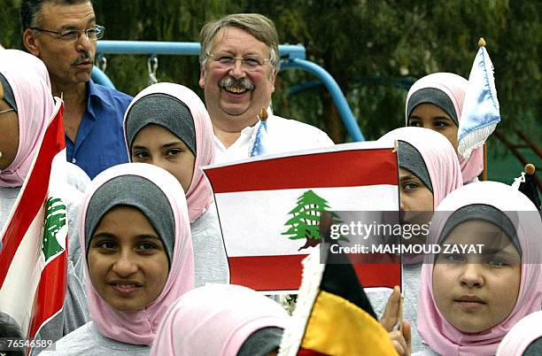 Belgian Defence Minister Andre Flahaut poses for picture with Lebanese orphans during his visit to an orphanage house in the southern villlage of...